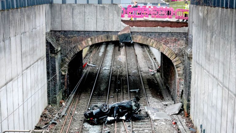 Major travel disruption after car crashes onto railway lines – driver arrested